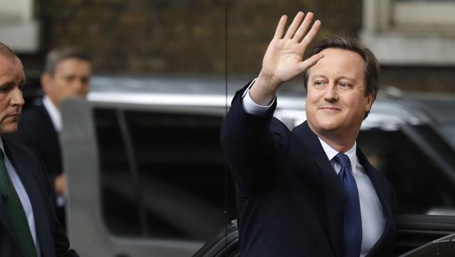 Britain's former prime minister David Cameron waves as he leaves 10 Downing Street in London