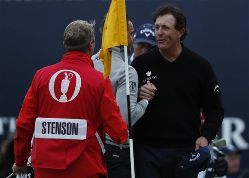 Phil Mickelson of the United States right shakes hands with Henrik Stenson of Sweden,on the 18th green after they completed their third round of the British Open Golf Championships at the Royal Troon Golf Club in Troon Scotland. AP