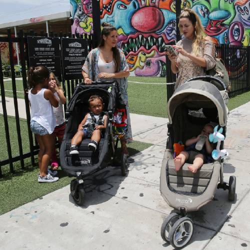 33 left with her son Ezra 2 and her friend Cristy Fernandez 33 with her 9-month-old son River of Miami walk in the Wynwood neighborhood of Miami Friday