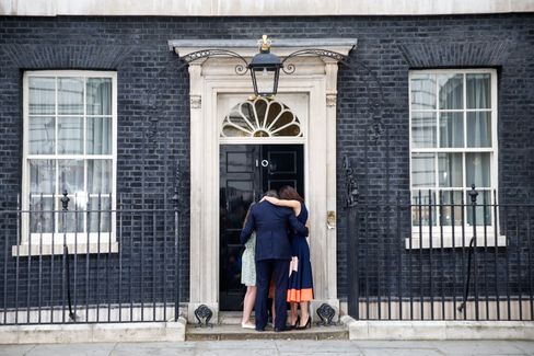 Cameron and his wife Samantha embrace with their children outside 10 Downing Street