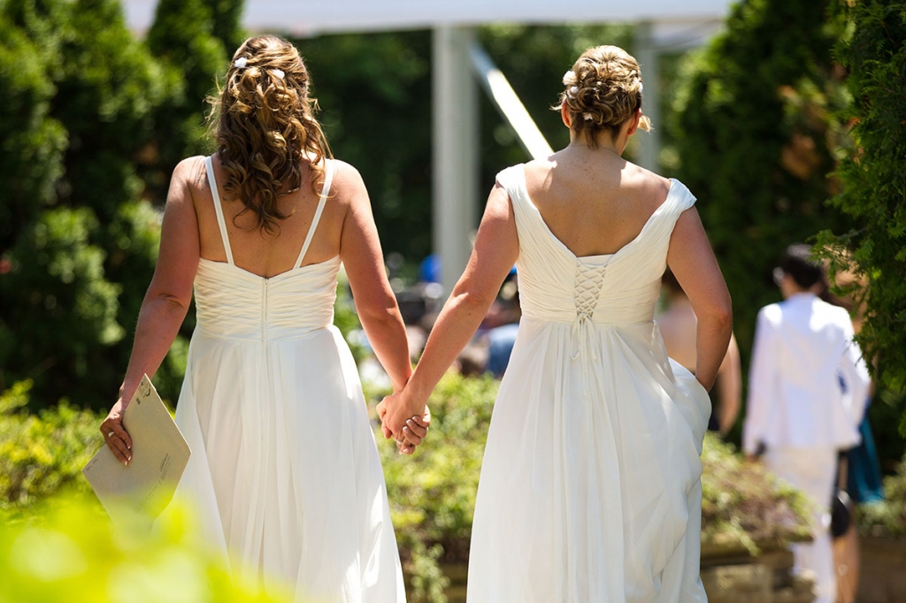 Cheryl Taylor and Jennifer Smith hold hands as they arrive for the Grand Pride Wedding a mass gay wedding at Casa Loma in Toronto Canada