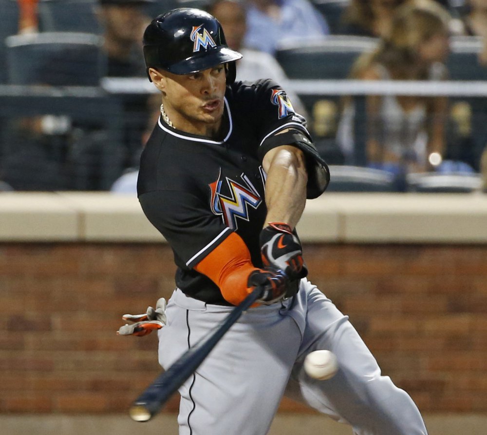 Giancarlo Stanton of the Miami Marlins hits a two-run homer Tuesday night in the seventh inning of the 5-2 victory against the New York Mets