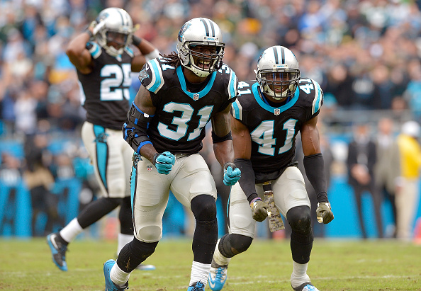 Charles Tillman and Roman Harper of the Carolina Panthers react after forcing a fumble by the Green Bay Packers during their game at Bank of America Stadium on Nov. 8 2015 in Charlotte