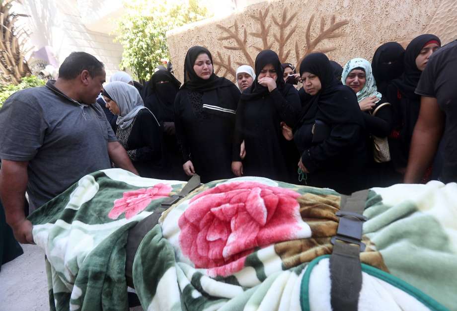 Mourners stand next to the body of Sondos al-Basha a Palestinian woman who was killed in the Istanbul airport attack blamed on the Islamic State group on June 28 during her funeral in the West Bank town of Qalqilyah