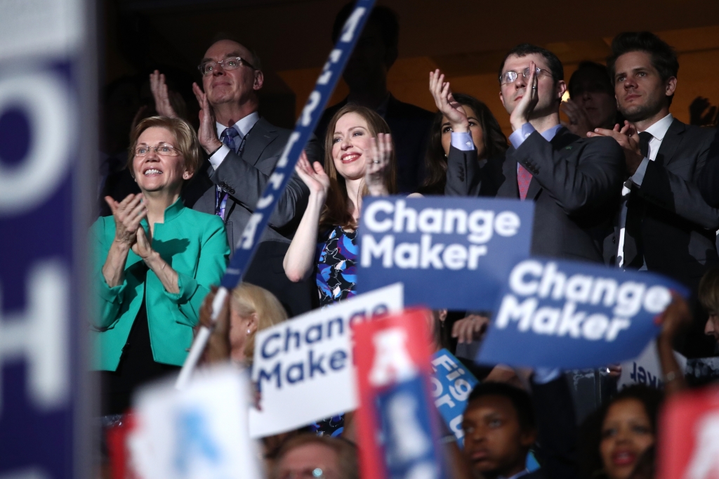 Chelsea Clinton and husband Marc Mezvinsky applaud former U.S. President Bill Clinton on the second day of the Democratic National Convention at the Wells Fargo Center