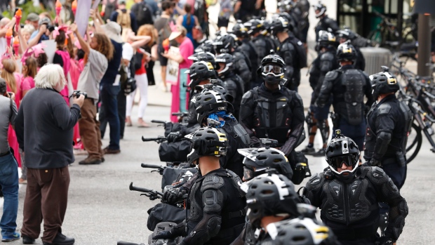 Demonstrators march by police during the Shut Down Trump & the RNC protest in Cleveland on Sunday