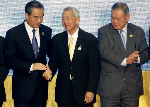 China's Foreign Minister Wang Yi left stands with Philippines Foreign Minister Perfecto Yassay center and Brunei's Foreign Affairs and Trade Minister Jock Seng Pehin Lim after they pose for