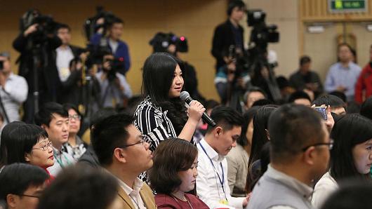 A journalist asks questions at a press conference