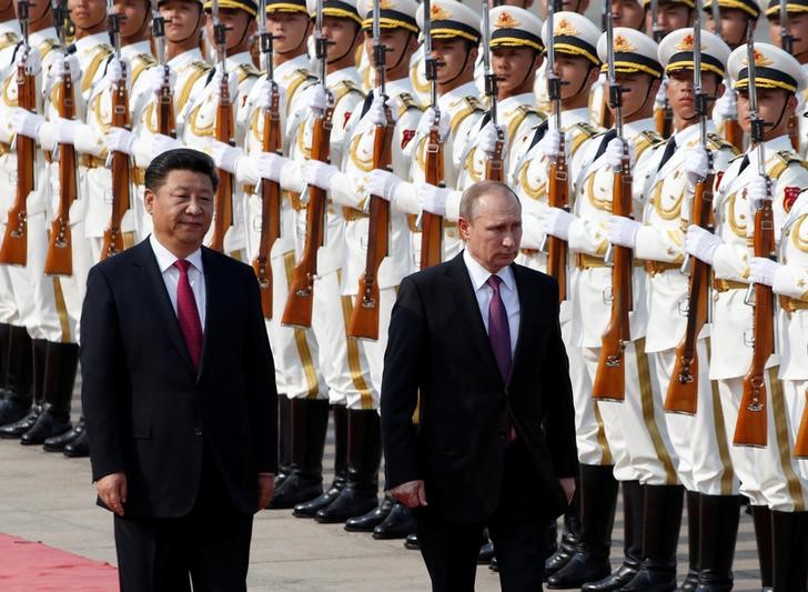 Russian President Vladimir Putin and his Chinese counterpart Xi Jinping attend a welcoming ceremony outside the Great Hall of the People in Beijing China