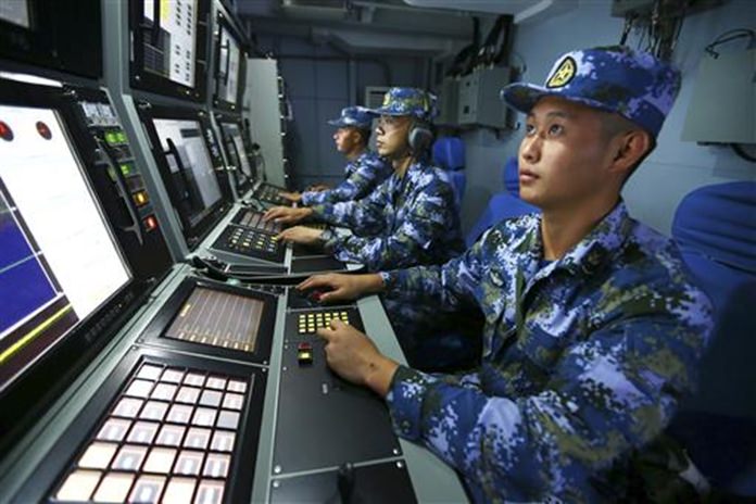 Chinese navy sailors search for targets onboard the missile destroyer Hefei during a military exercise in the waters near south China's Hainan Island and Paracel Islands