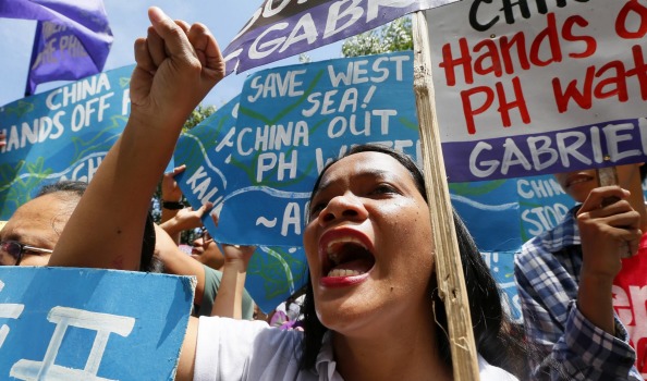 No voice in ASEAN? Filipino protesters shout slogans during a rally outside the Chinese consulate near Manila hours