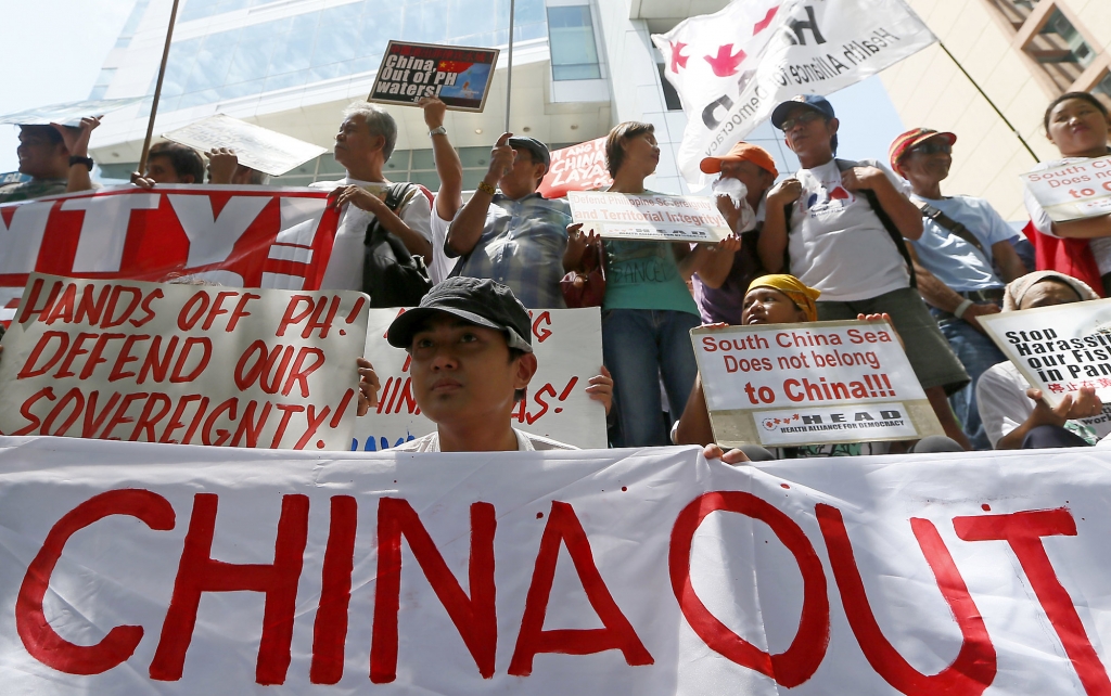 Protesters display their message during a rally outside of the Chinese Consulate hours before the Hague-based UN international arbitration tribunal is to announce its ruling on South China Sea Tuesday