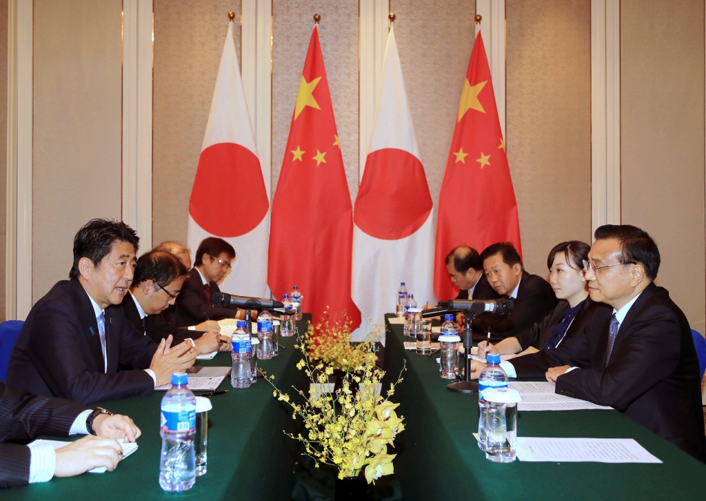 Japanese Prime Minister Shinzo Abe left speaks to Chinese Premier Li Keqiang right during a bilateral meeting held on the sideline of the 11th Asia Europe Meeting Summit in Ulaanbaatar Mongolia Friday