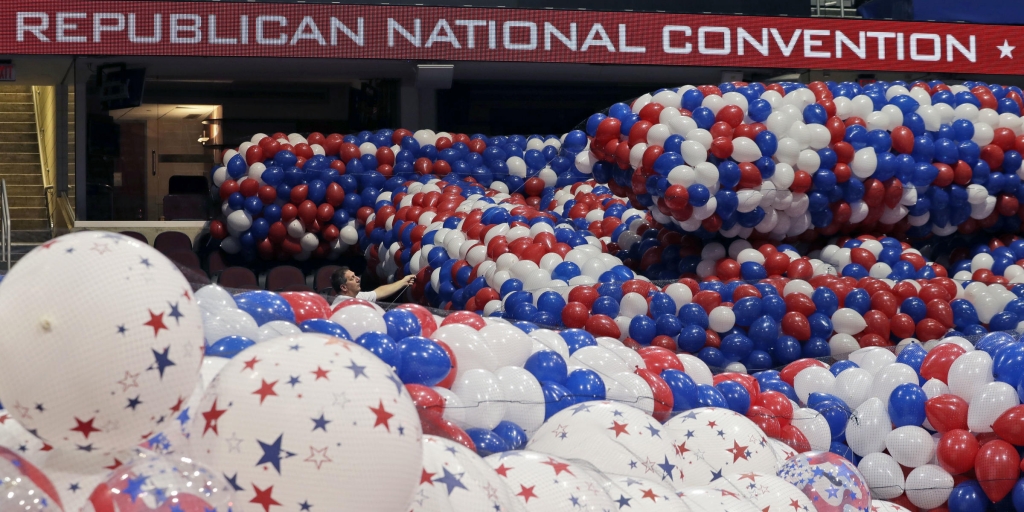 Dave Strnisa left moves a bag of balloons as preparations continue for the Republican National Convention Friday