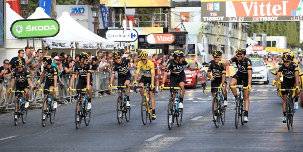 Chris Froome crosses the finish line on the Champs Elysees avenue with his team-mates to win the Tour de France