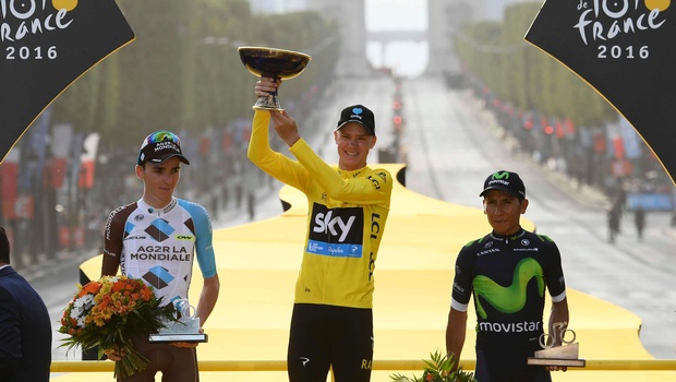 Britain's Chris Froome wearing the overall leader's yellow jersey second place Romain Bardet of France left and third place Nairo Quintana of Colombia right celebrate on the podium after the twenty-first and last stage of the Tour de France cycling