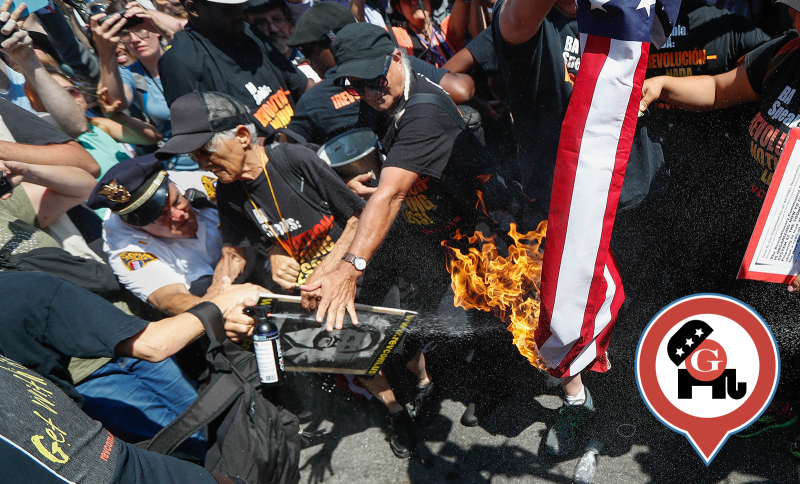 Cleveland police spray a burning American flag with a fire extinguisher