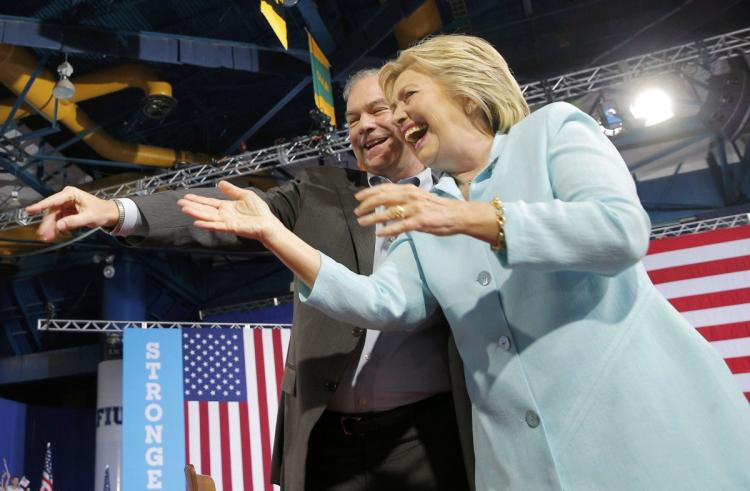 Democratic U.S. presidential candidate Hillary Clinton arrives on stage with U.S. Sen. Tim Kaine as her vice presidential running mate Saturday at a Miami campaign rally