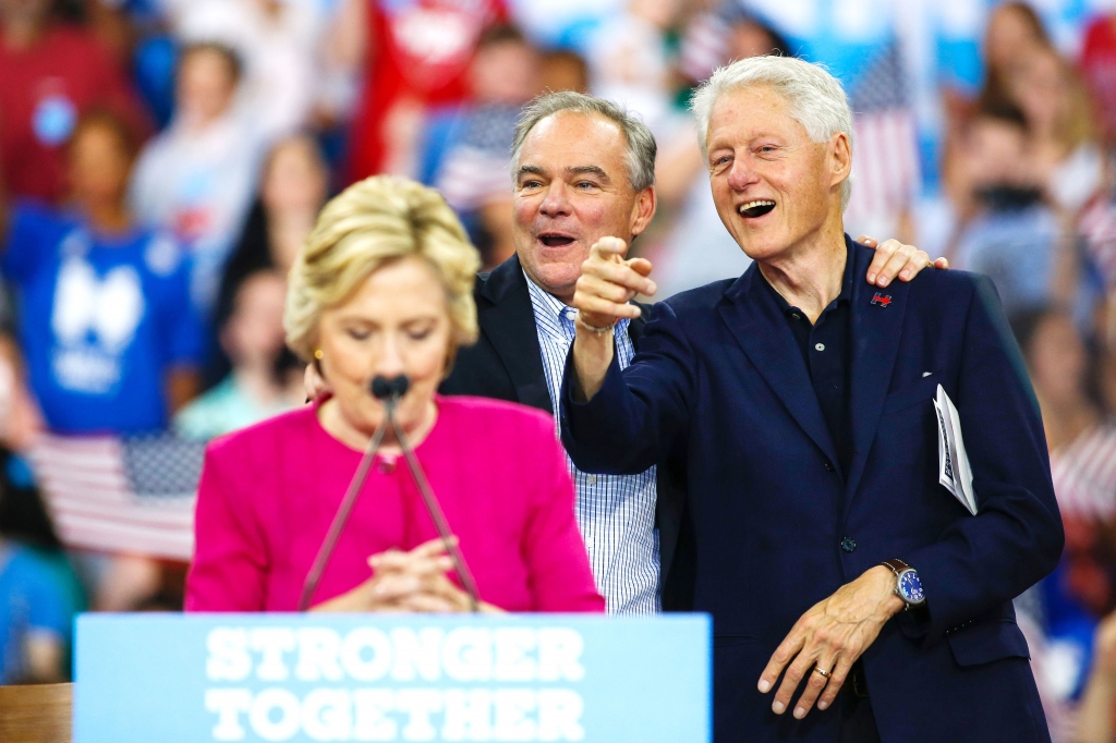 Phillymain0730025 Former President Bill Clinton right talks with vice presidential candidate Tim Kaine while Democratic presidential nominee Hillary Clinton gets ready to speak to supporters during a rally Friday in Philadelphia