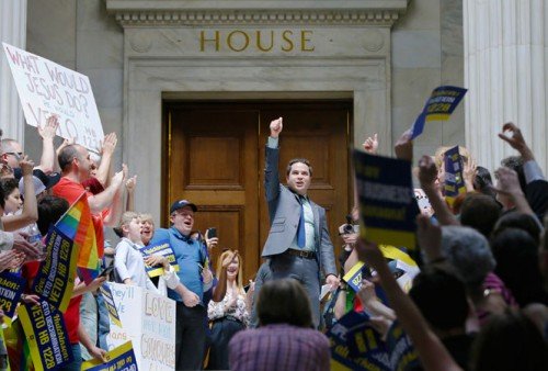 Rep. Warwick Sabin D Little Rock center cheers with protesters outside of the House chamber at the Arkansas state Capitol in Little Rock Ark. Monday