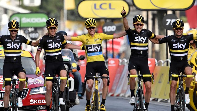 Froome celebrates with Team Sky as they cross the line in Paris