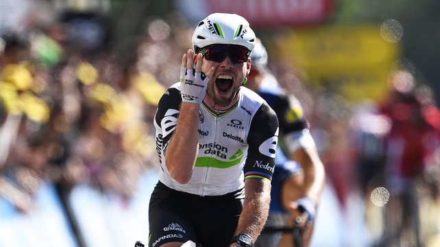 Mark Cavendish celebrates as he crosses the line in Villars-les-Dombes