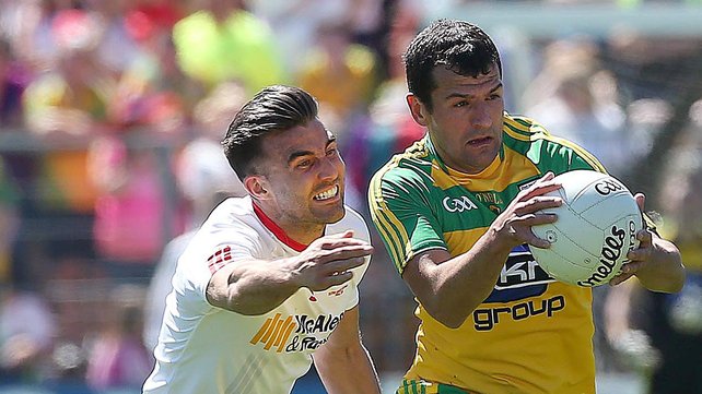 Tyrone's Tiernan Mc Cann tackles Frank McGlynn