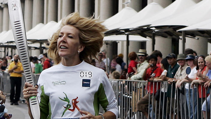 Commonwealth games gold medallist Jane Flemming carries the Commonwealth Games Queen's Baton through Circular Quay in Sydney in 2006