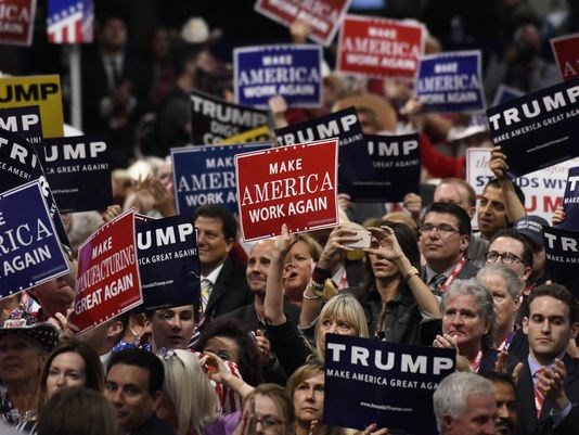 Convention-goers listen to Donald Trump Jr. speak during the Republican National Convention