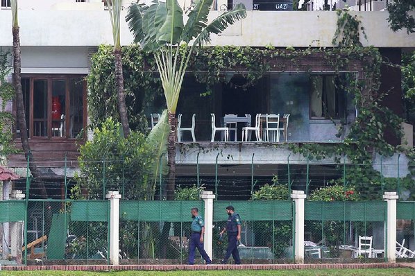 Credit AP				Bangladeshi police officers walk past the Holey Artisan Bakery in Dhaka’s Gulshan area on Sunday