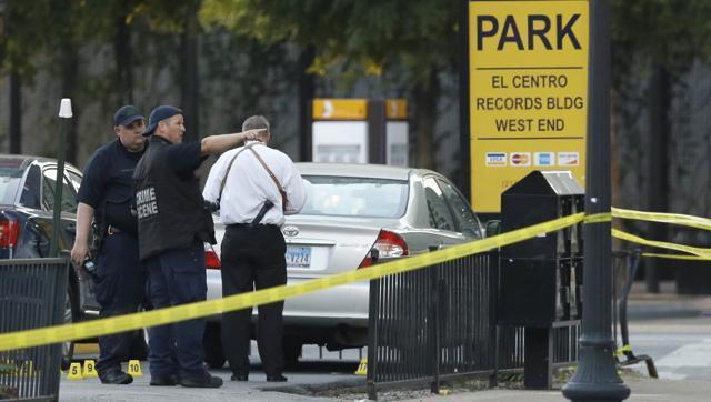 Crime scene investigators survey the area after a shooting in downtown Dallas