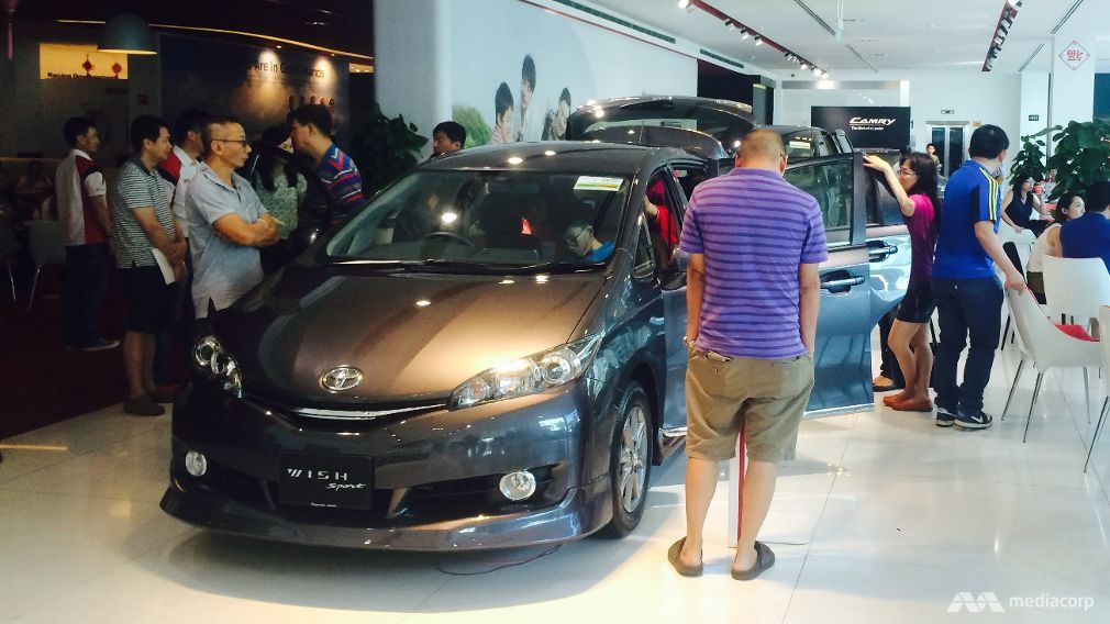 Customers at a car showroom.
   
 

  Enlarge  Caption