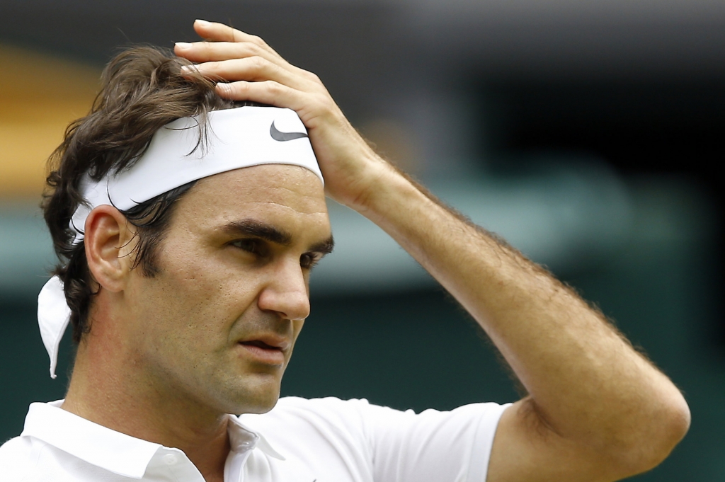 Roger Federer of Switzerland looks on during his men's singles match against Steve Johnson of the U.S on day eight of the Wimbledon Tennis Championships in London Monday