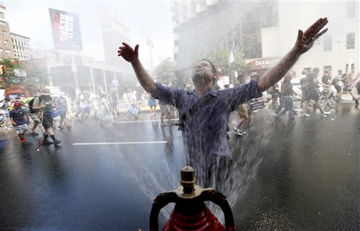 A supporter of Sen. Bernie Sanders I-Vt. cools off during a march in downtown on Sunday