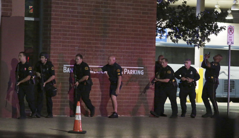 FILE- Dallas police respond after shots were fired during a protest over recent fatal shootings by police in Louisiana and Minnesota in Dallas on Thursday