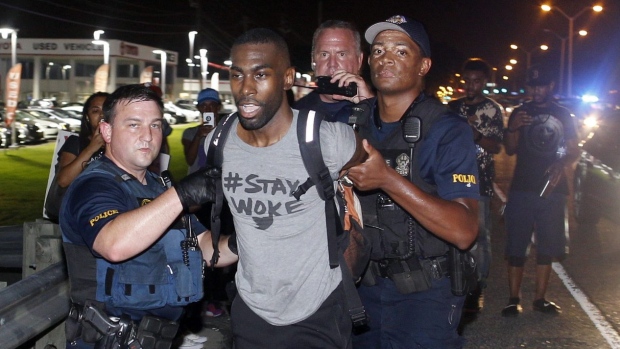 Police arrest activist De Ray McKesson during a protest along a major road that passes in front of the Baton Rouge Police Department headquarters