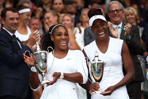 LONDON ENGLAND- JULY 09 Venus Williams of The United States and Serena Williams of The United States hold their trophies following victory in the Ladies Doubles Final against Timea Babos of Hungary and Yaroslava Shvedova of Kazakhstan on day twelve