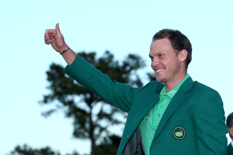 Danny Willett of England celebrates with the green jacket after winning the final round of the 2016 Masters