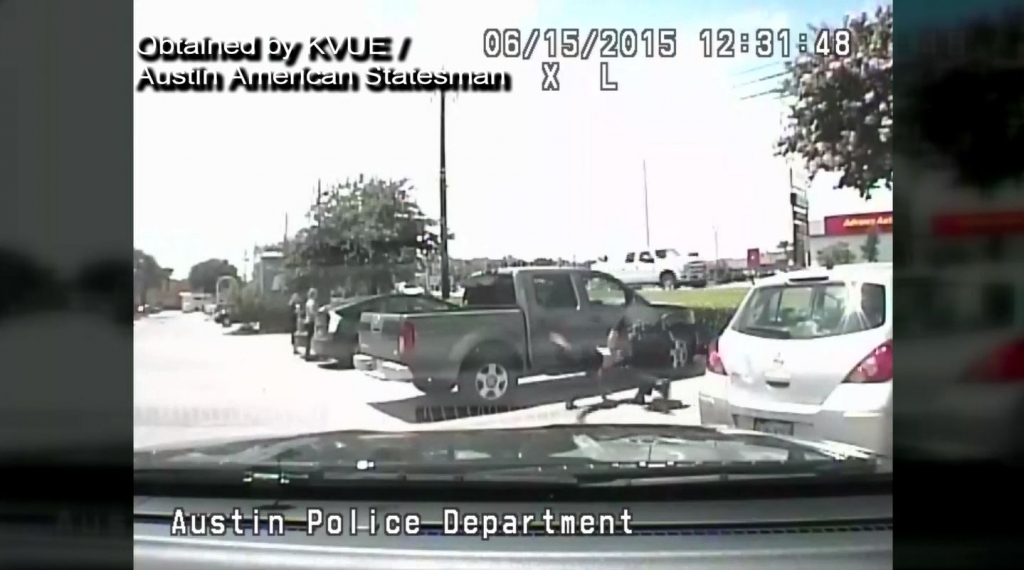 Dash camera still of Austin Police Officer Bryan Richter throwing Breaion King to the ground