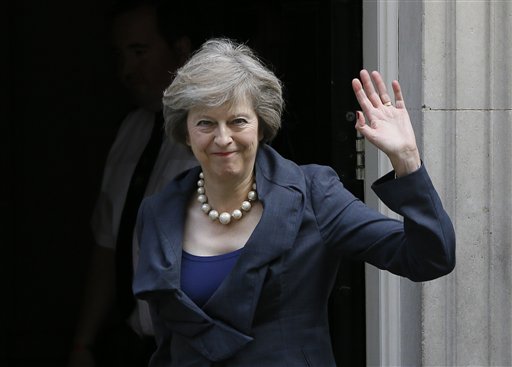 Britain's Home Secretary Theresa May waves towards the media as she arrives to attend a cabinet meeting at 10 Downing Street in London Tuesday