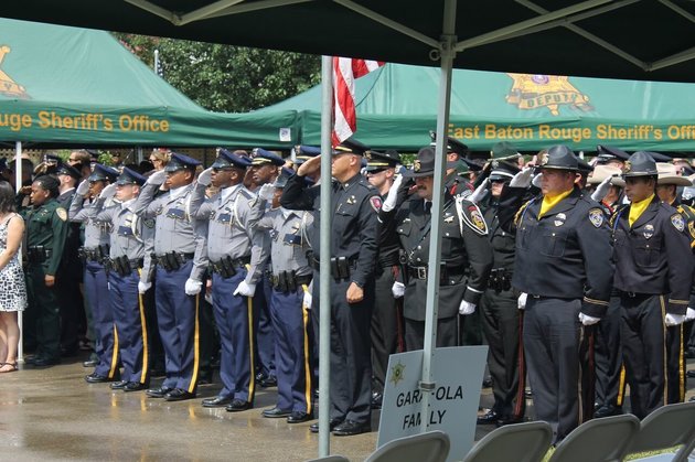 David Lohr  The Huffington Post
Officers pay their respects at the funeral for Deputy Brad Garafola