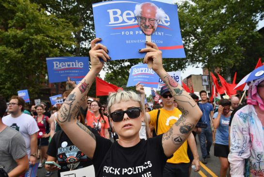 Bernie Sanders supporters march through downtown on the first day of the Democratic National Convention