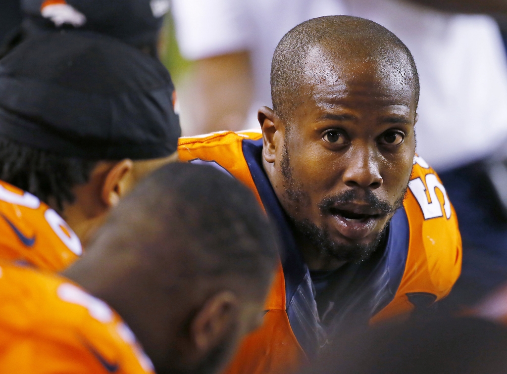 Denver Broncos outside linebacker Von Miller talks with teammates during an NFL football game against the Kansas City Chiefs in Denver. A person with knowledge of the negotiations tells The Associated Press that