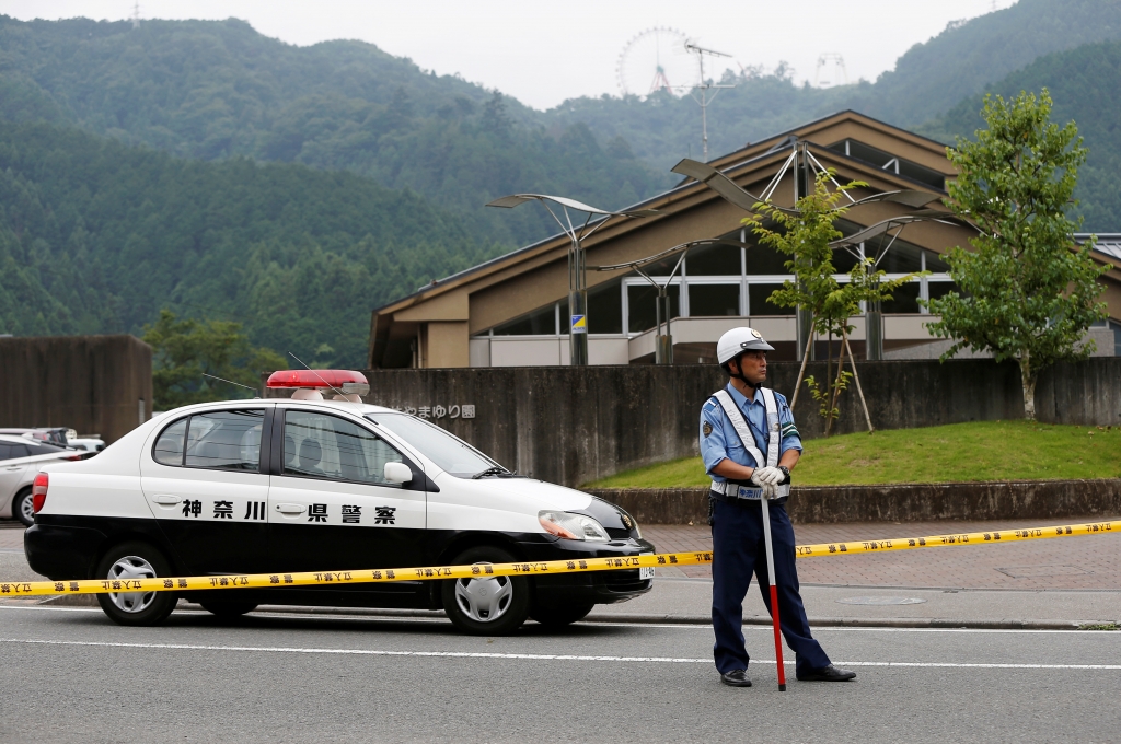 A police officer stands guard in front of a facility for the disabled where a deadly attack by a knife-wielding man took place in Sagamihara Japan