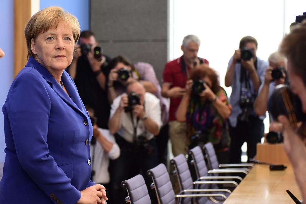 Defiant Merkel defends refugee stance after Germany attacks