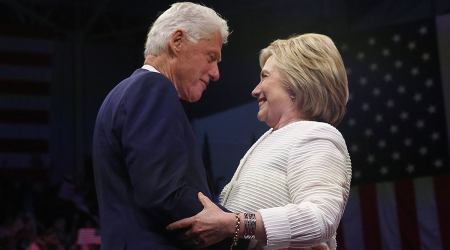 Democratic U.S. presidential candidate Hillary Clinton stands onstage with her husband former President Bill Clinton