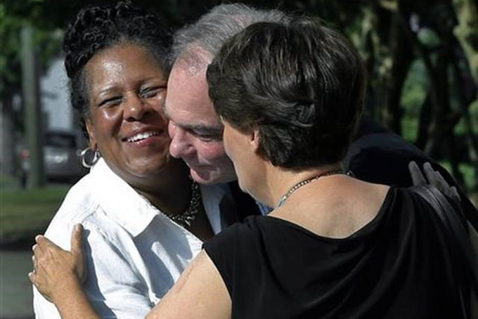 A fellow parishoner left of St. Elizabeth's Catholic Church in Richmond Va. greets Sen. Tim Kaine center and his wife Anne Holton as they arrive for Mass at St. Elizabeth Catholic Church their longtime parish Sunday