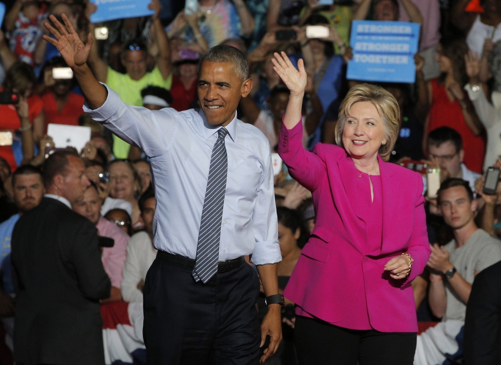 President Barack Obama waves with Democratic U.S. presidential candidate Hillary Clinton during a Clinton campaign event in Charlotte