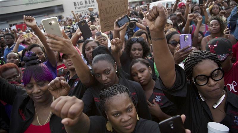 Demonstrators mourned the loss of Alton Sterling chanting'black lives matter and'hands up don't shoot