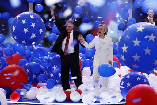 Democratic vice presidential nominee Sen. Tim Kaine D-Va. and Democratic presidential nominee Hillary Clinton walk through the falling balloons during the final day of the Democratic National Convention in Philadelphia, Thursday